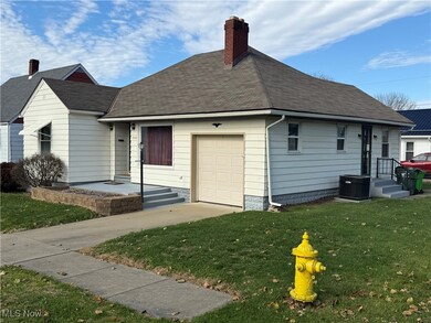 View of front of property with a chimney, roof with shingles, and a front yard