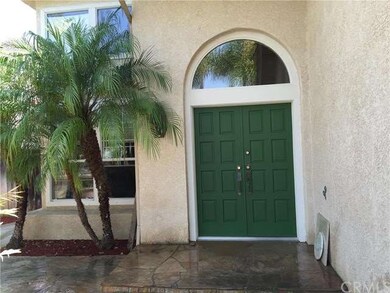 FRONT STONE PATIO AND DOUBLE DOOR ENTRY