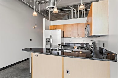 Kitchen featuring a sink, a high ceiling, applianc