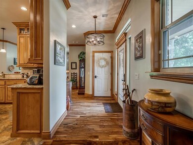 Entryway featuring hardwood floors, crown molding.