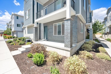 View of property exterior with brick siding and a balcony