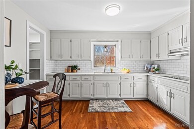 Kitchen with white cabinets, decorative backsplash