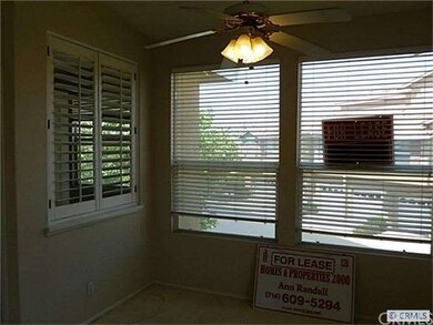 Dining room with ceiling fan and light, next to ki