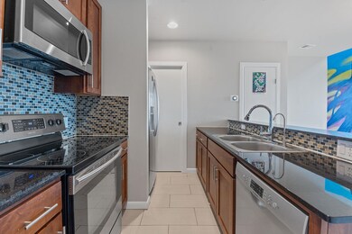 Kitchen featuring backsplash, light tile patterne
