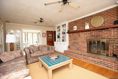 Living room with a fireplace, crown molding, ceili