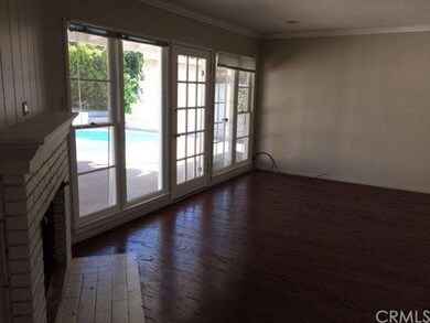 living room has fireplace and looks onto the pool 
