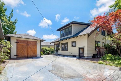 View of front of home with an outdoor structure and a garage
