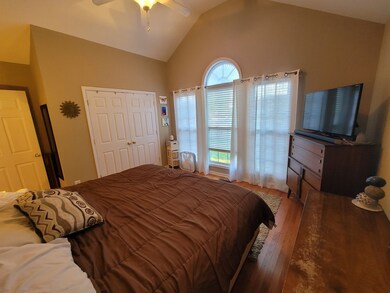 Large bedroom with lots of natural light and tall ceiling
