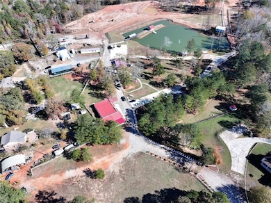 Aerial view of property and surrounding area with a nearby body of water