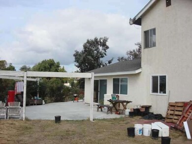 Left to right, small part of back yard shows entry