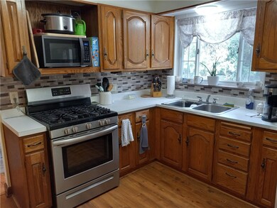 Newer SS appliances and backsplash in kitchen.