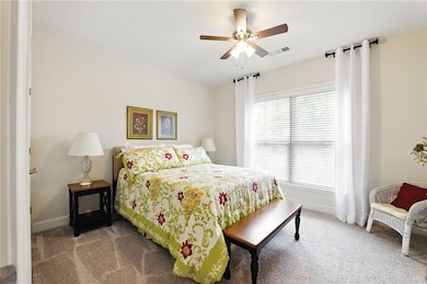 Bedroom featuring carpet, baseboards, and a ceilin