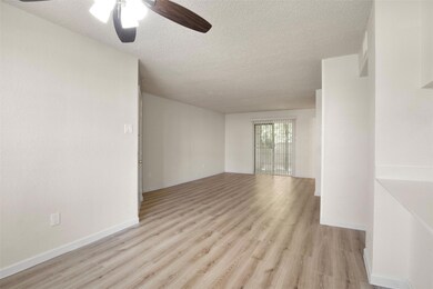 Unfurnished room with ceiling fan, a textured ceil