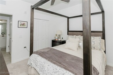 Carpeted bedroom with a closet and ceiling fan