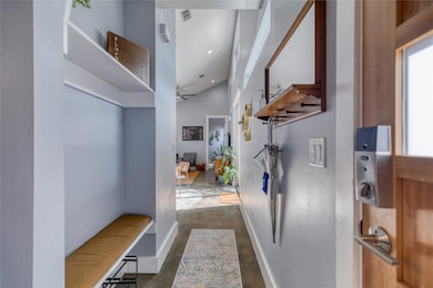 Hall featuring finished concrete floors, baseboar