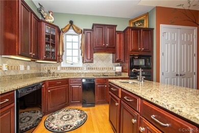 The kitchen features Cherry Cabinets, Tile backspl