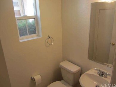 Main floor guest bath has pedestal sink and huge u