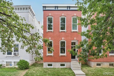 Italianate home featuring brick siding and a front lawn