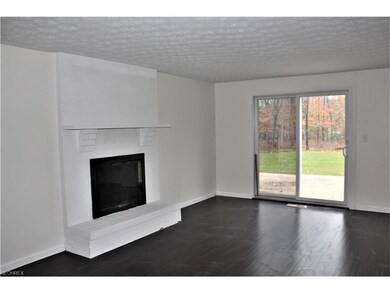 Family Room with Fireplace and Sliding Doors to De
