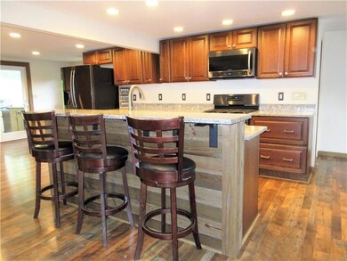 The custom kitchen has beautiful quartz countertop