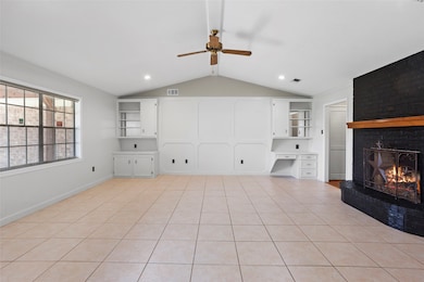 This spacious living room features a cozy fireplac