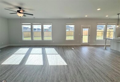 Unfurnished living room featuring baseboards, dark