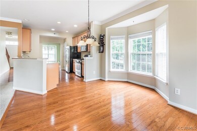 Kitchen opens into breakfast nook with bay window,