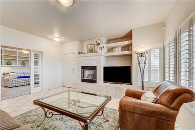 Living area featuring light tile patterned flooring and a tile fireplace