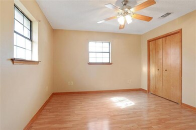 Master bedroom has neutral color walls and laminat