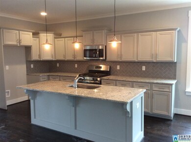 Gourmet kitchen features granite countertops, stai