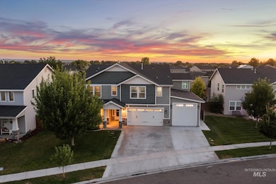 View of front of house featuring a residential view, driveway, a front lawn, stone siding, and board and batten siding