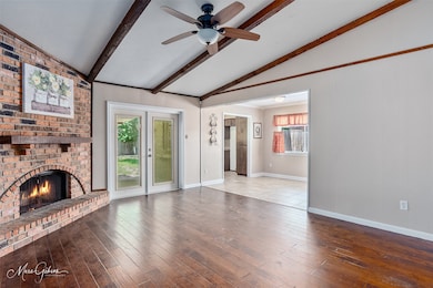 Unfurnished living room with a fireplace, hardwood / wood-style floors, and a ceiling fan