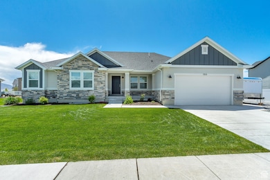 Craftsman-style house featuring stone siding, board and batten siding, concrete driveway, and a garage