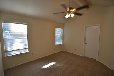 Empty room featuring carpet floors and ceiling fan