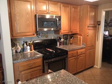 Kitchen with brown cabinets, light tile patterned