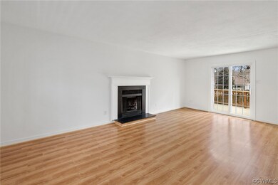 Open Family Room with Wood Burning Fireplace and L