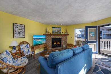 Living room featuring a fireplace, a textured ceil