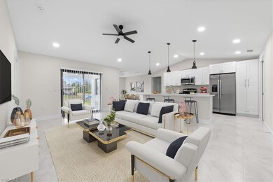 Living room featuring lofted ceiling, recessed lighting, a ceiling fan, and light marble finish flooring