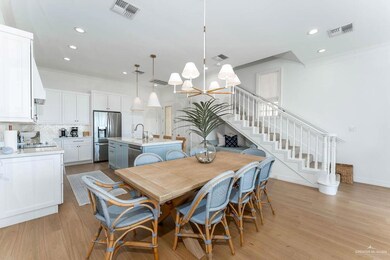 Dining space with ornamental molding, a chandelier, recessed lighting, light wood-style floors, and stairway