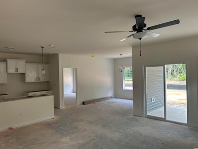 Unfurnished living room featuring concrete floors, a ceiling fan, a baseboard radiator, and a chandelier