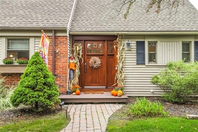 A Spectuacluar hardwood front entry door greets yo
