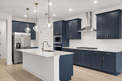 Kitchen with wall chimney range hood, stainless s