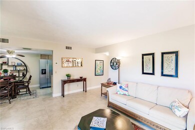 Living room with light tile patterned floors and ceiling fan