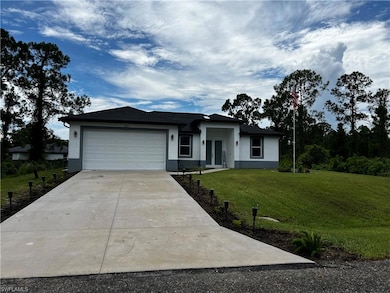 View of front facade with an attached garage, driv