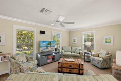 Living room with ornamental molding, a healthy amo