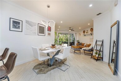 Dining room featuring light wood-type flooring, ornamental molding, recessed lighting, and ceiling fan