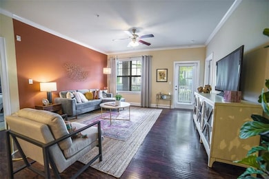 Living room with crown molding, dark hardwood / wo