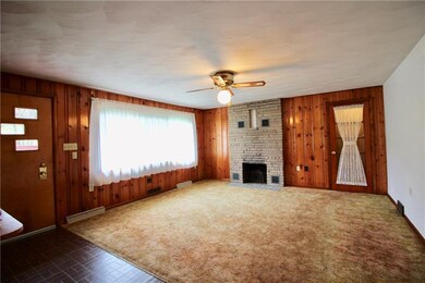 Living room with a wood fireplace. Get warm and co