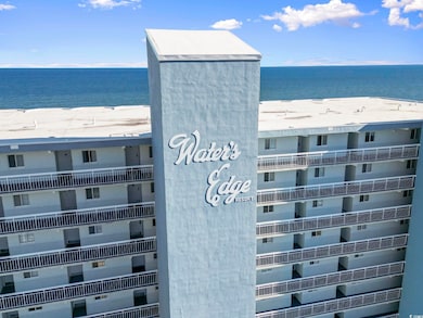 View of building exterior featuring a beach view a