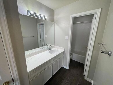 Bathroom with shower / tub combination, wood fini